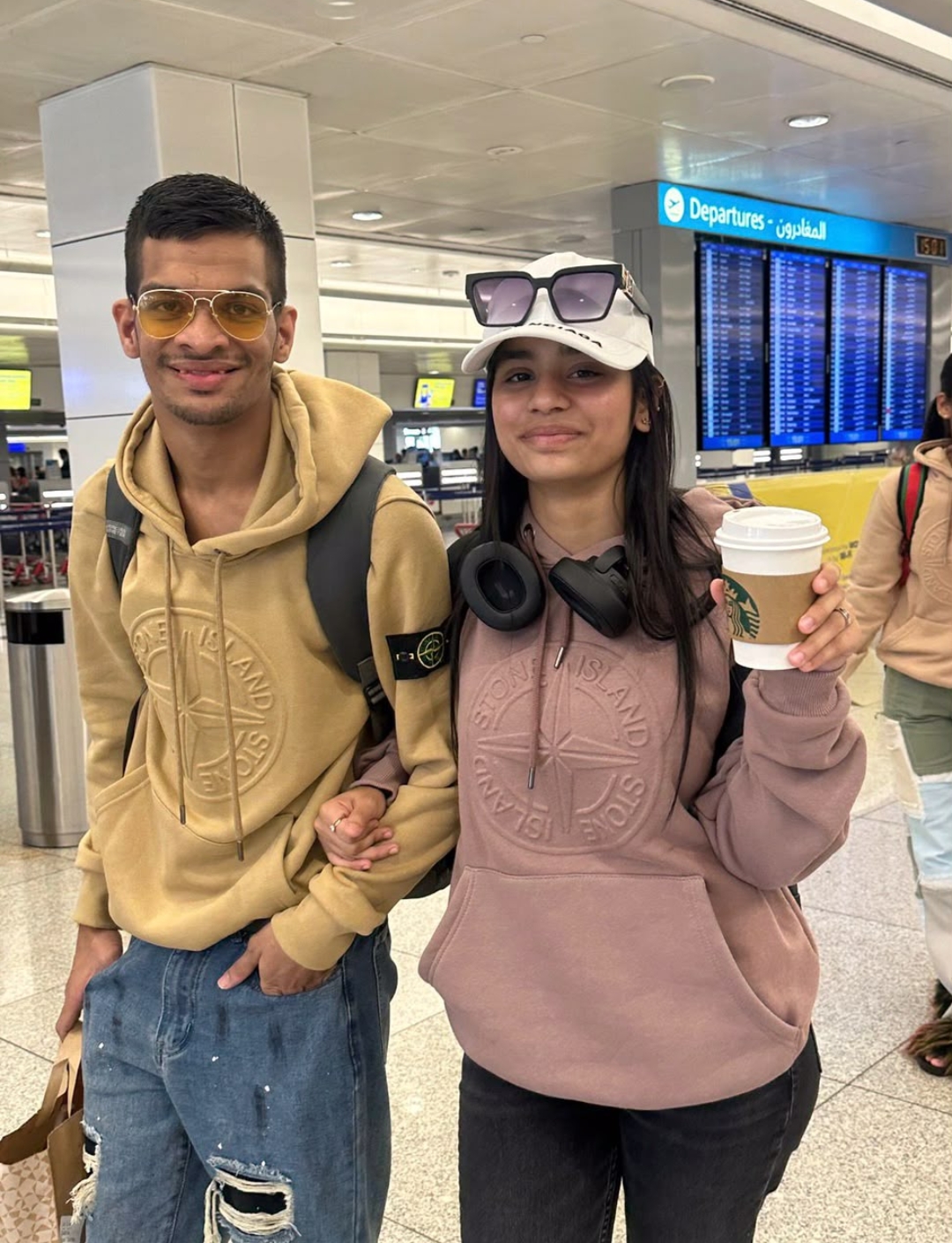 Brother and sister together at an airport